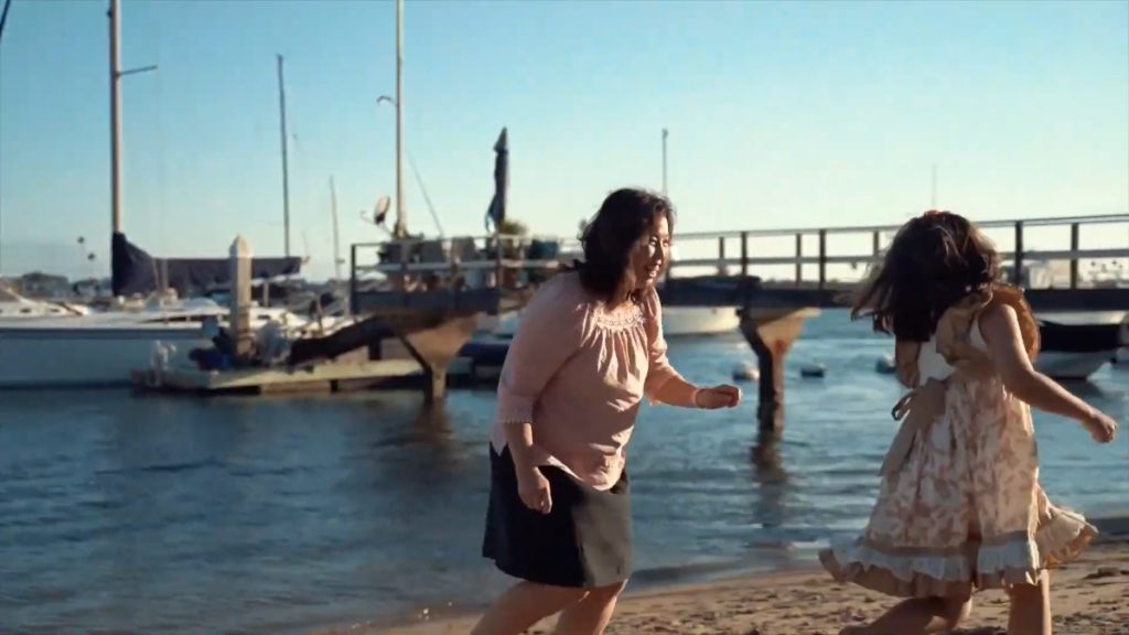 grandmother and daughter playing on beach